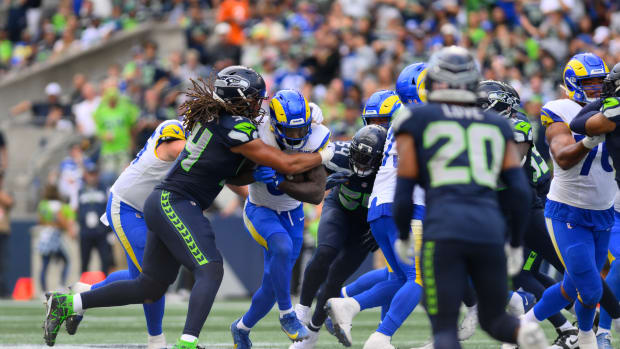 Sep 10, 2023; Seattle, Washington, USA; Los Angeles Rams running back Cam Akers (3) carries the ball while Seattle Seahawks defensive end Mike Morris (94) tries to tackle during the second half at Lumen Field. Mandatory Credit: Steven Bisig-USA TODAY Sports